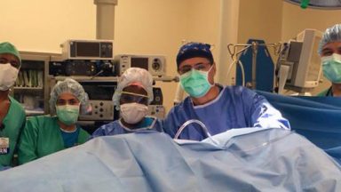 Doctors operating on a wounded child.