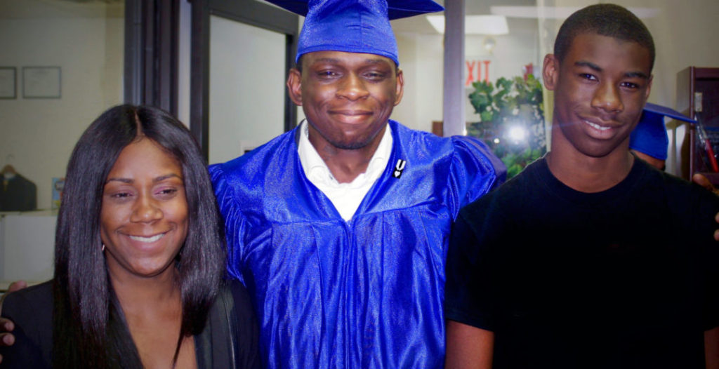 Seen above centered is VRL member: Wilfride Dextra, surrounded his by loved ones during the graduation ceremony held in Queens, NY.