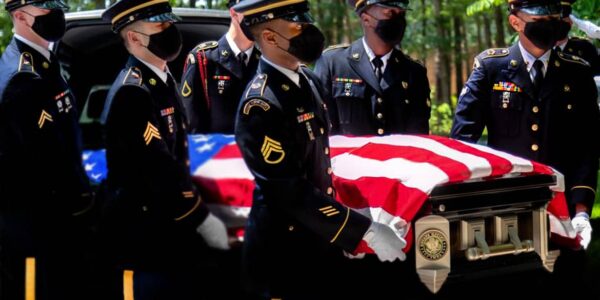 Military honor guard during memorial service for the fallen.