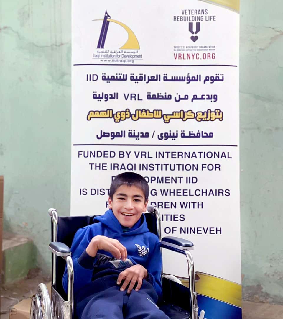 Seen here, is one of the 14 disabled children to receive a new wheelchair and hearing aide, through the 2023 humanitarian mission conducted by Veterans Rebuilding Life, and the Iraqi Institution for Development.