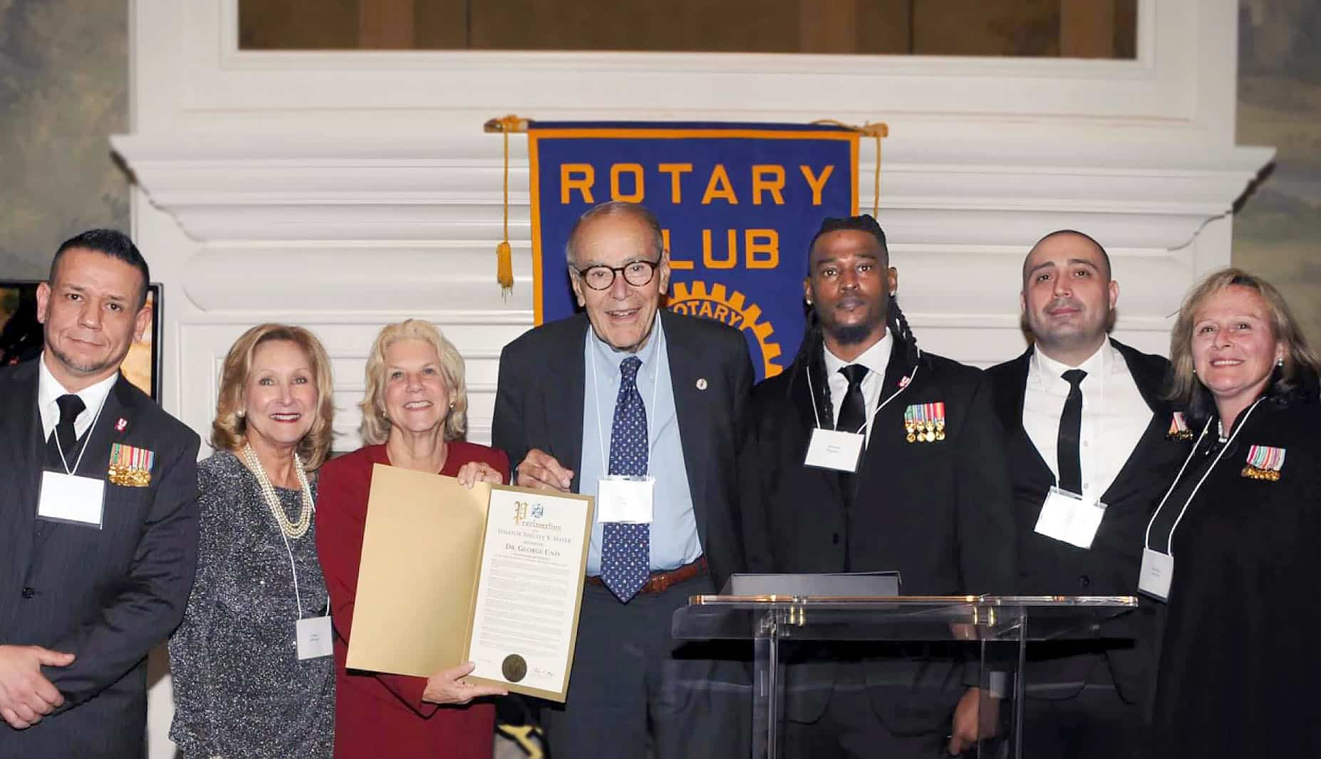 Centered: Dr. George Unis was honored at the Rotary's annual gala for his medical service.