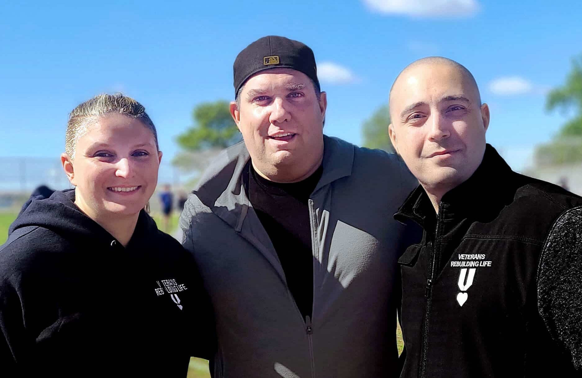 Centered: Mike Klein of Riptide Athletics, with Dami December and Chris Zamora of Veterans Rebuilding Life.