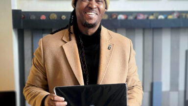 Afghanistan War Veteran Antonio Ingram, holding a new laptop provided by VRL as he begins his first semester of college this year.