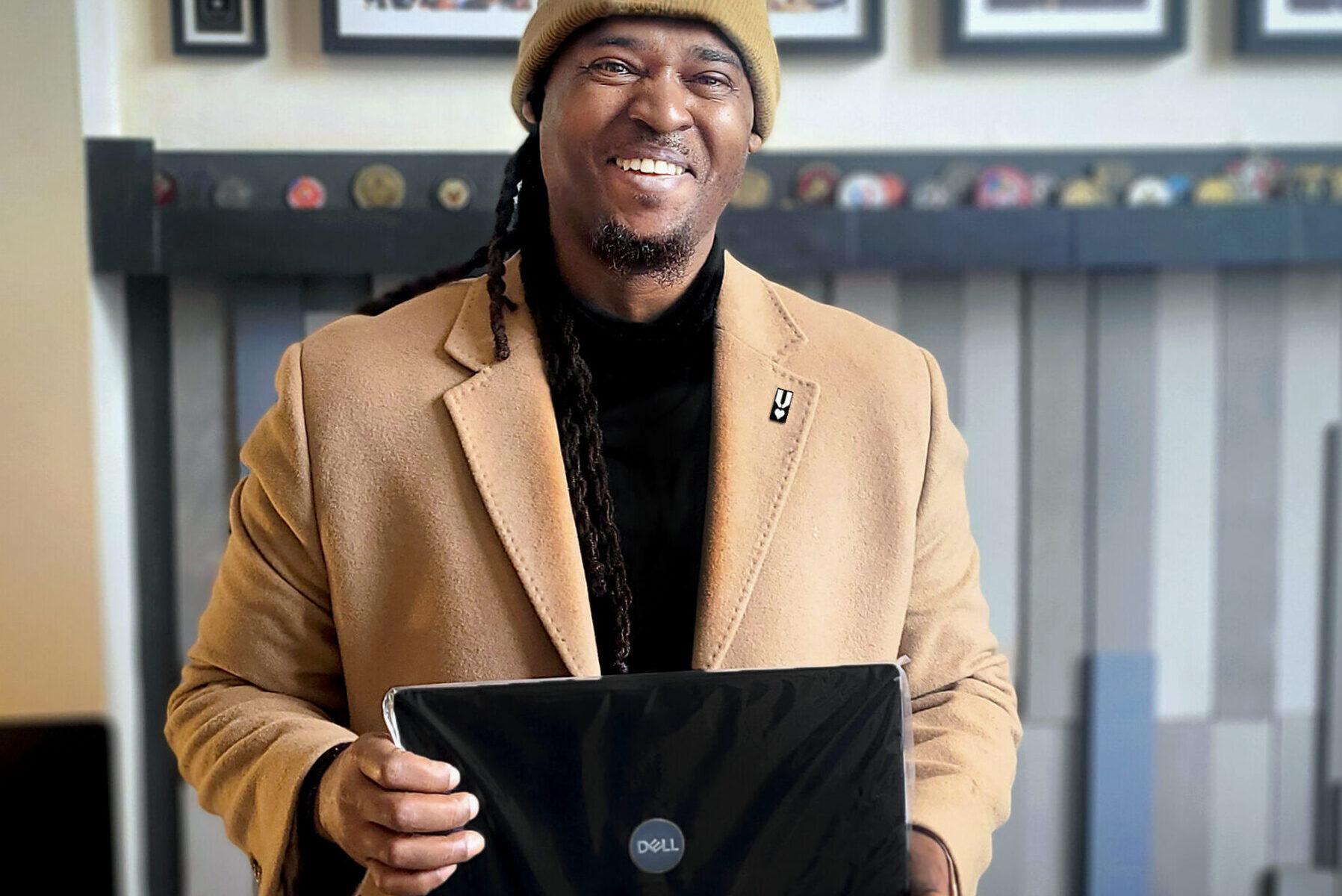 Afghanistan War Veteran Antonio Ingram, holding a new laptop provided by VRL as he begins his first semester of college this year.