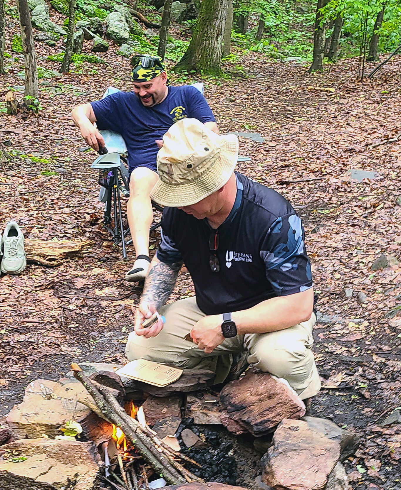 Marine combat veteran Matthew Foresta, ignites the camp fire.